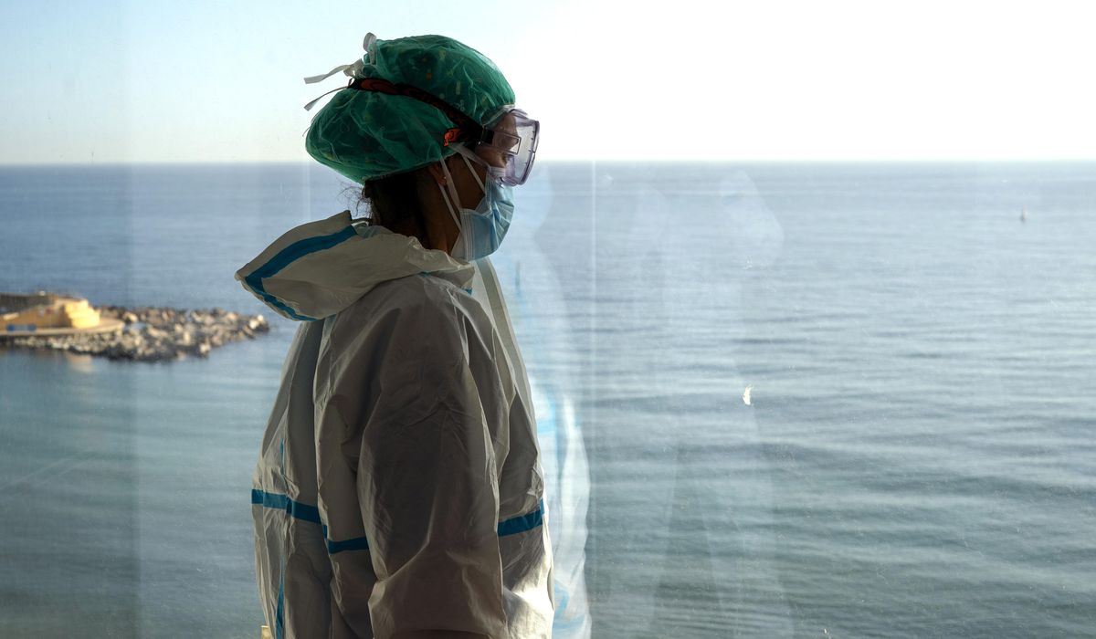 AP Photos: Spanish nurses witness grim solitude of
COVID-19 1