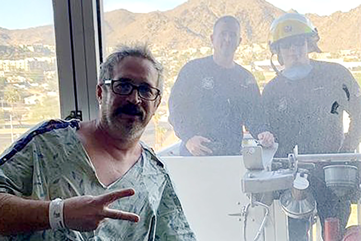 Fire crew uses ladder to surprise colleague hospitalized
with COVID-19 1