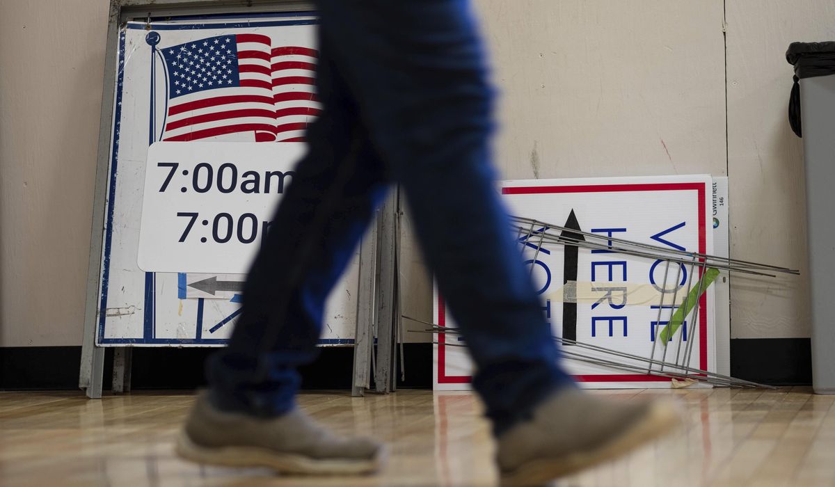The Latest: Polls open for key Senate runoffs in
Georgia 1