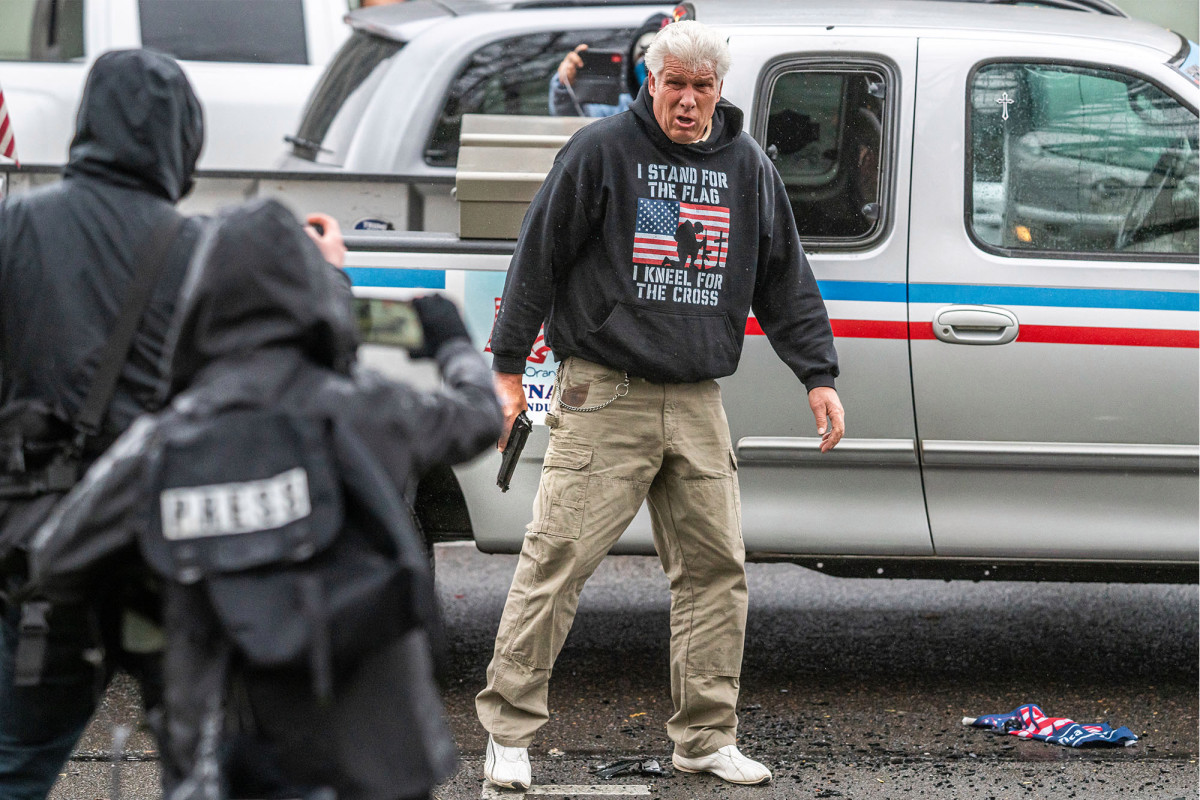 No charges for man who drew gun at dueling Oregon protests;
four others arrested 1