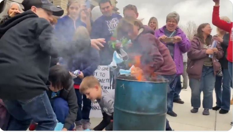 'Destroy Them!' Children Burn Face Masks on Steps of Idaho
Capitol in Anti-Mask Rally 1