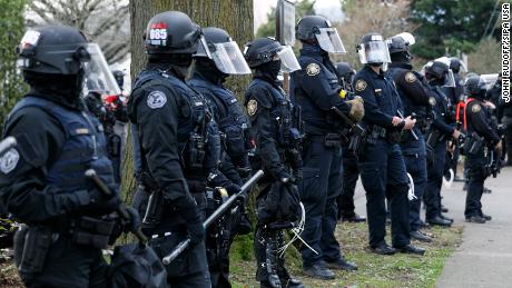 Dozens of Portland police officers resign from team that
responds to protests after member is indicted 1