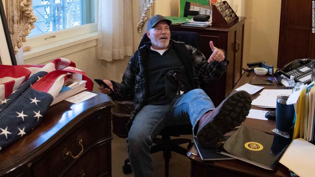 Man who put his feet on desk in Pelosi's office during
Capitol riot to be released from jail pending trial 1
