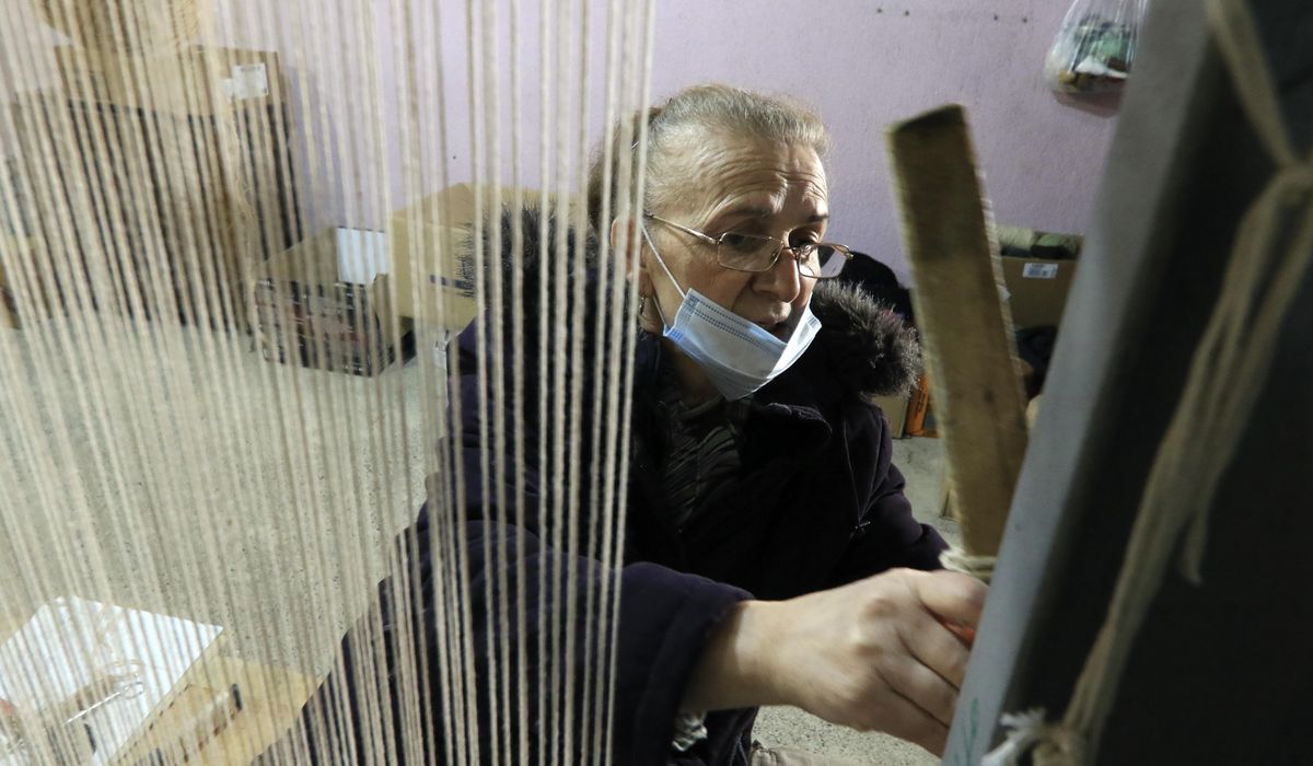 Training opens 'a window of hope' for Albanian
rug-weavers 1