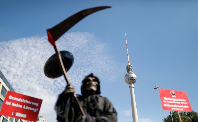 'Grim Reaper' Walks German Streets in Protest of Brazil's
'Deadly Health Policies' 1