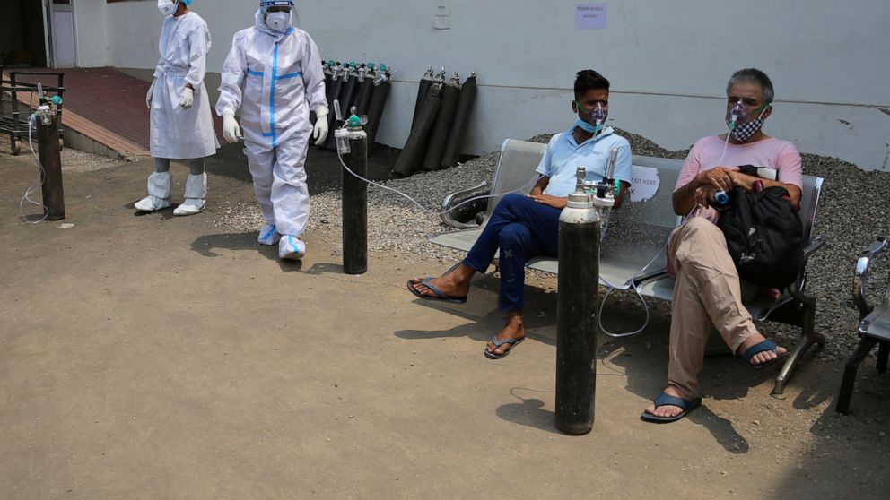 Pressure rises for India lockdown; surge breaks record
again 1