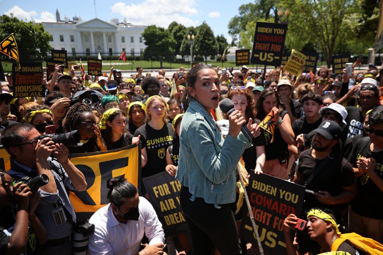 AOC Joins Climate Protesters With 'Biden You Coward, Fight
For Us' Signs Outside White House 1