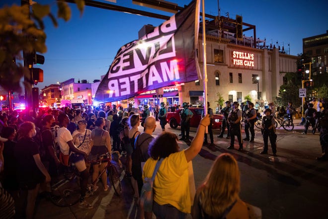 One woman dead, three injured after car plows into
protesters in Minneapolis, police say 1