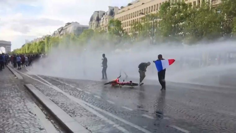 French Covid protester faces legal trouble over poster
depicting Macron as Hitler 1