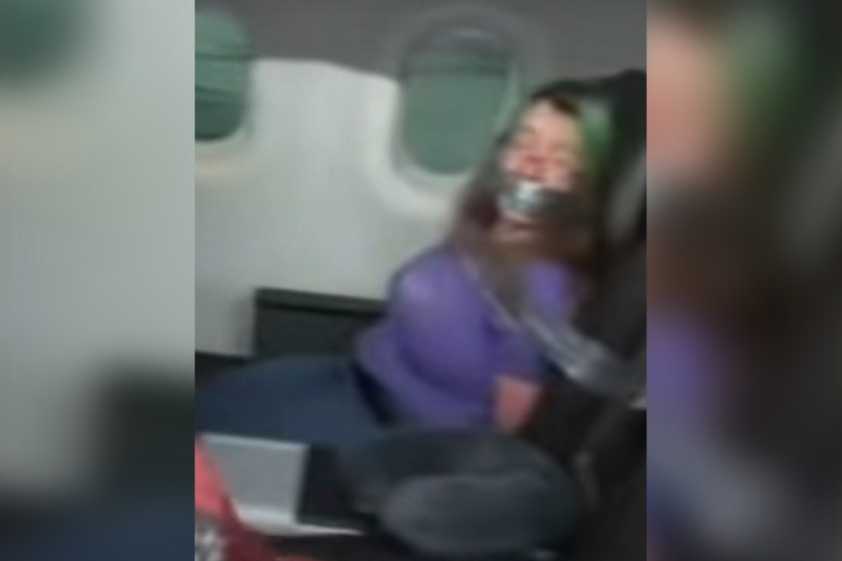 Video shows woman duct-taped to seat after trying to open
airplane door 1