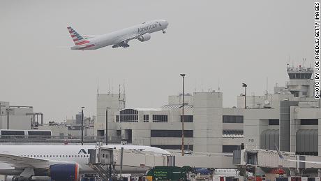 Passenger on plane arriving at Miami airport opens emergency
exit, walks onto wing 1