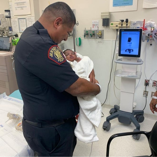 Police officer catches baby dropped from second-story
balcony in Jersey City 1