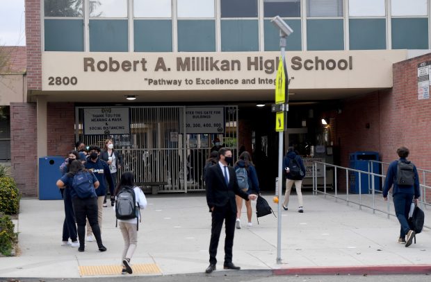 18-year-old woman in critical condition after school safety
officer fires at car near California high school, police
say 1