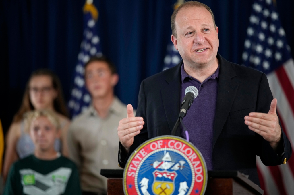 Polis says Coloradans may need booster to be “fully
vaccinated” against COVID-19 1
