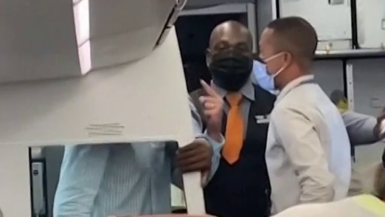 Man accused of trying to open airplane door wanted to be
videotaped to share views on Covid vaccine, authorities say 1