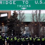 Police begin to remove protesters blocking Canada-U.S.
bridge hours after judge ordered truckers to go home 8