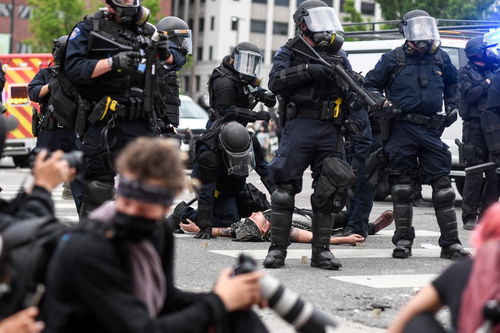 Two Denver police officers suspended for excessive force for
using pepper spray, baton on peaceful protesters 1