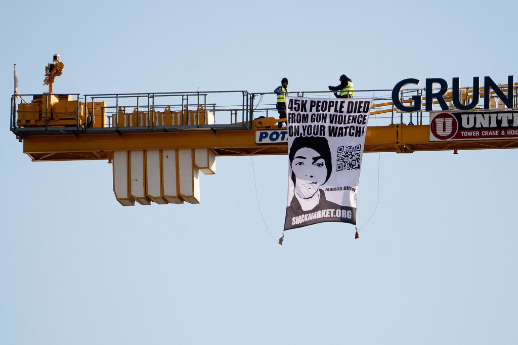 Father of teen killed in the Parkland school shooting climbs
crane to protest Biden 1