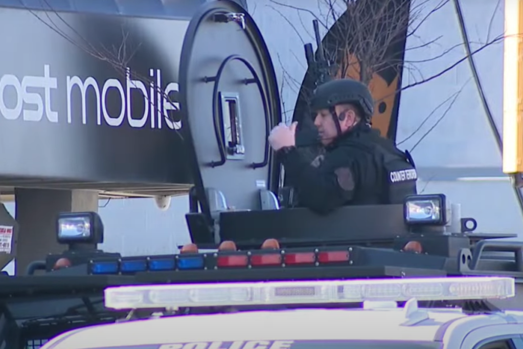 Philadelphia SWAT officer shot in bulletproof vest, suspect
in custody, police say 1